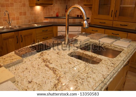 Warm Modern contemporary kitchen showing granite worktop  in showroom