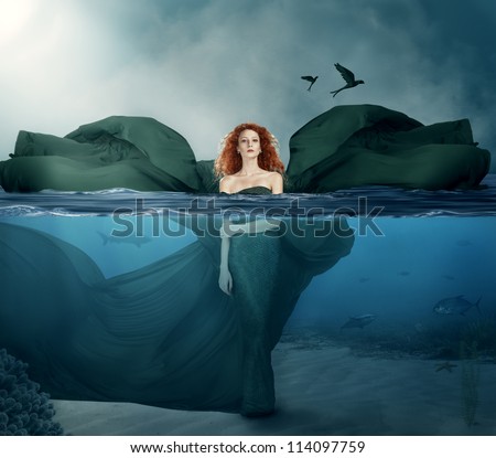 beautiful red haired goddess standing in the water.manipulated.