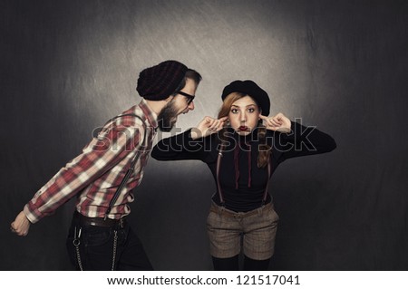 young nerdy girl not listening young nerdy man shouting on grunge background