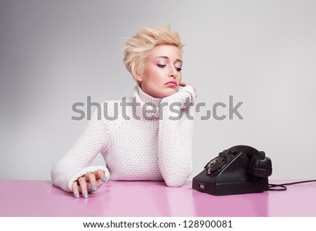 unhappy young girl waiting for phone ring despairingly