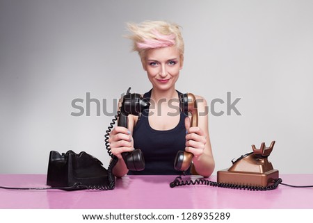 young lady with crazy hair holding handset to each other and having fun