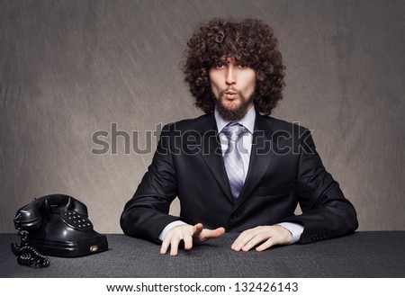 bored young businessman giving a whistle while waiting for the phone ring on grunge background