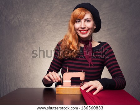 young beautiful lady with a retro sewing machine looking at you on grunge background