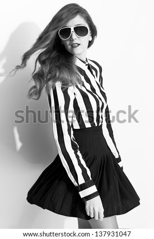 black and white picture of a beautiful model turning around and posing on white background