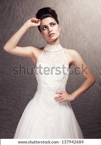 portrait of young beautiful bride posing on grunge background