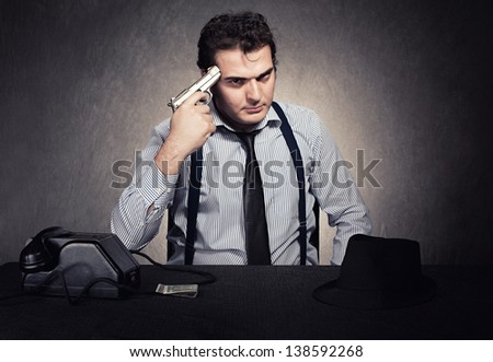retro style gangster trying to kill himself with a gun on his head on grunge background