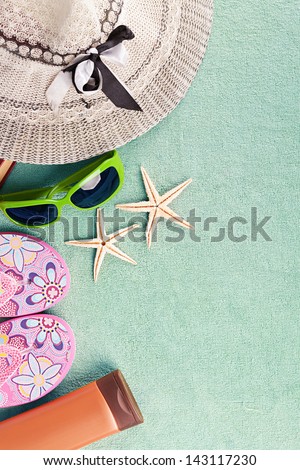 turquoise beach towel with several summer stuff