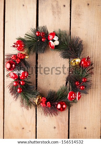 evergreen christmas wreath on old wooden door background
