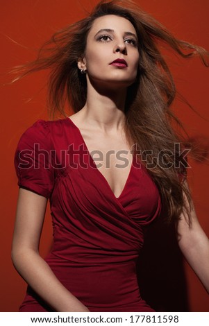 beautiful young lady with green spring dress on blue and red background