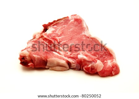 Raw veal loin chop on a white background
