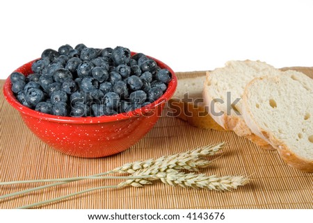 Bowl of fresh blueberries with slices of bread for a person to eat for breakfast to stay healthy