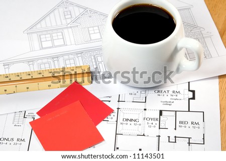 Home design drawings and a coffee on an architects desk