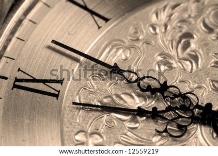 Close up view of an antique clock face with hour and minute hands