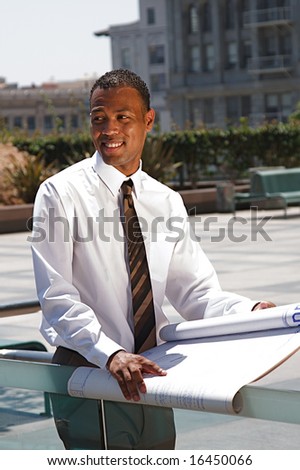 An African-American young urban professional architect surveying the city