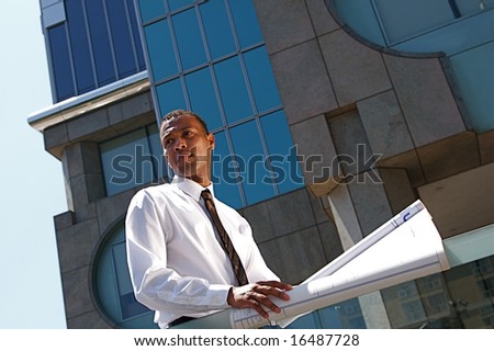 An African-American young urban professional architect surveying the city