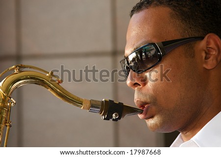 An young and trendy African-American sax musician