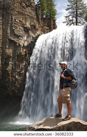 Rugged hiker views the wild terrain at Rainbow Falls in the Devils Postpile NM