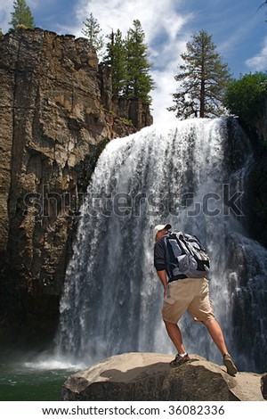 Rugged hiker views the wild terrain at Rainbow Falls in the Devils Postpile NM