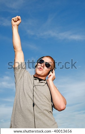 A cool young man listens to music on some headphones