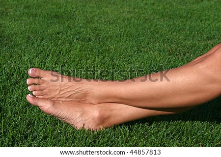 Relaxed feet of a woman laying in the grass