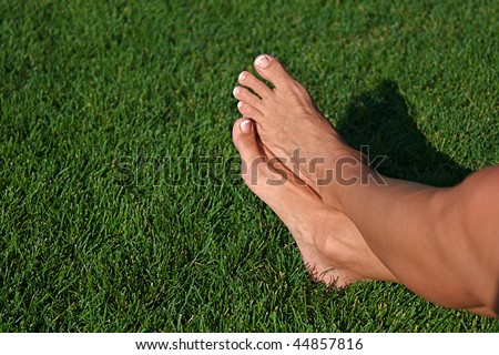 Relaxed feet of a woman laying in the grass
