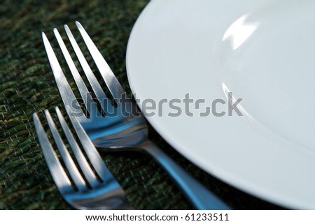 Modern silverware arranged in a place setting on a table