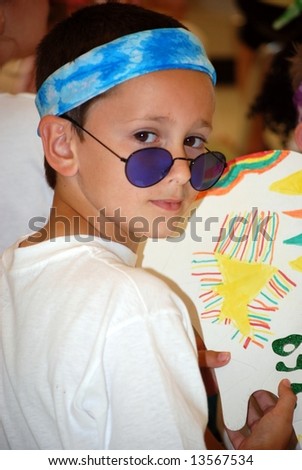 Young boy dressed as a youth of the 60\'s.