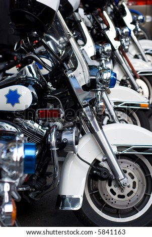 A row of parked Police motorcyles - symbol of order and security.