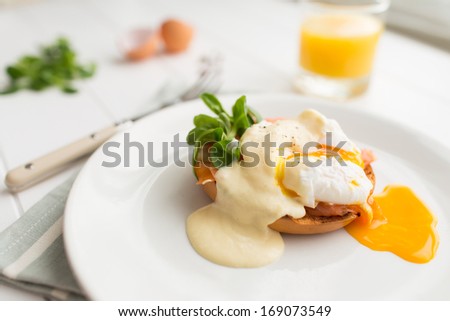 Poached eggs royale with salmon, sauce hollandaise, salad and fresh orange juice