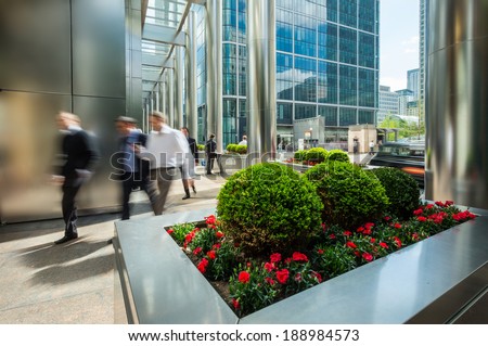 Businessmen walking outside of modern office buildings