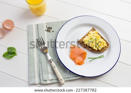 Top view of high protein breakfast with eggs and salmon on white wooden background