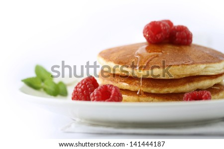 Pancakes with raspberry and honey on top