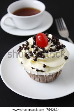 chocolate cupcake with vanilla butter cream and cherry on top