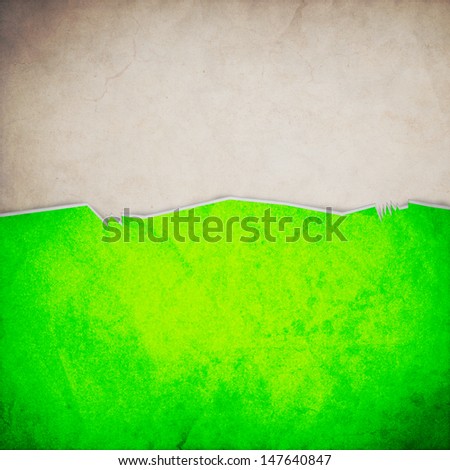 Riped old paper on grunge wall background