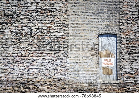 Valet Parking Sign on old wooden door with brick wall background