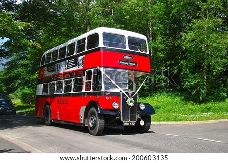 KESWICK, ENGLAND - JUNE 5. A veteran double deck bus in use as wedding transport  on June 5, 2014, Keswick, England.