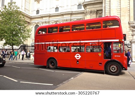 LONDON - AUGUST 10: Routemaster Bus operating in London on August 10, 2015 in London, UK. The open platform facilitated speedy boarding under the supervision of a conductor.