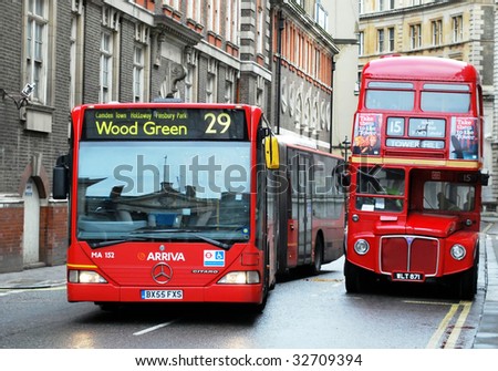 LONDON - JUNE 26: An articulated bus (L) passes one 50 years its senior on June 26, 2009. The Mayor has indicated that articulated buses will be replaced with double deckers by the end of 2011.