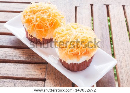 Gold egg yolk thread cakes on white dish, stock photo