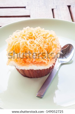 Gold egg yolk thread cup cake on ceramic dish, stock photo