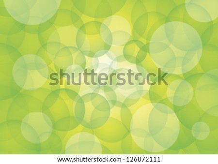 Green circles on white rays of light and bluish background.