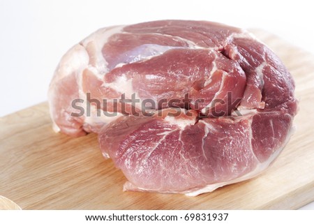 Raw pork shoulder on a cutting board