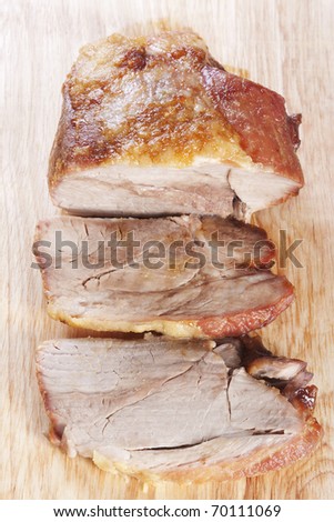 Roast pork shoulder sliced on a cutting board