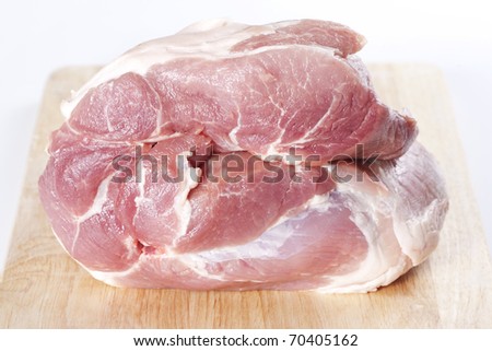 Raw pork shoulder on a cutting board