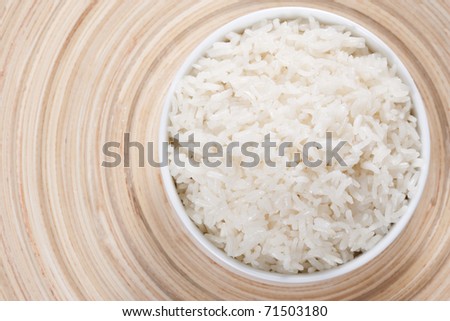 Rice in a bowl on a bamboo plate. Concept of the importance of rice