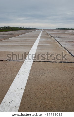Airport runway after rainfall. White line on runway.Airport runway after rainfall. White line on runway.