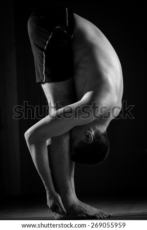 guy doing yoga in the gym, black and white