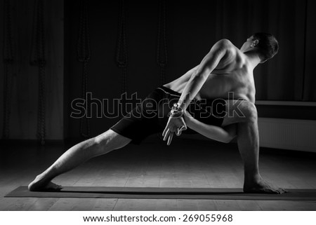 young guy doing yoga , black and white