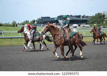 LEXINGTON, KY - AUGUST 10: Jockies warming up their horses before a race at Keeneland Horse Racing Track on August 10, 2011 in Lexington, Kentucky.