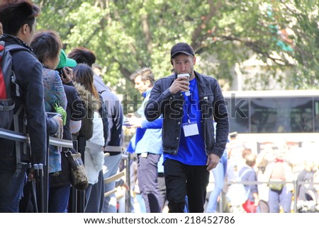 NEW YORK CITY - SEPTEMBER 19: An Apple Store associate sips coffee to stay awake while monitoring the crowd of people lined up to purchase the new iPhone 6 on September 19, 2014 in New York, NY.